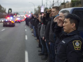 First responders line Grandview Highway in Vancouver, B.C. on Thursday, Nov. 9 to pay their respects to Abbotsford police Constable John Davidson, killed while on duty.