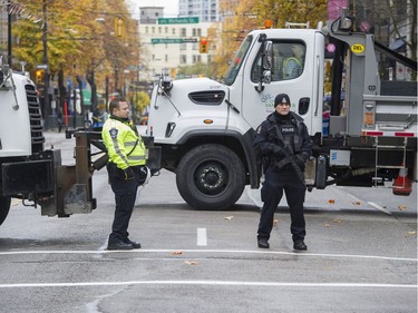 Dump trucks and armed police block Hastings Street near the annual Remembrance Day ceremony at the Victory Square Cenotaph in Vancouver, BC Saturday, November 11, 2017.