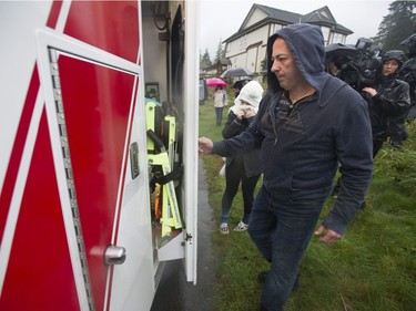 Annette Poitras' husband and daughter climb into the ambulance with Annette after she was rescued.