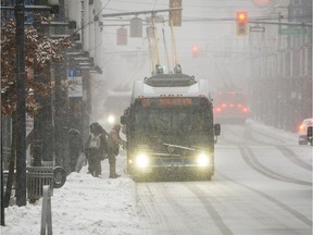 Heavy blowing  snow covered commuters and pedestrians making their way across Granville street in downtown Vancouver on February 6, 2017.