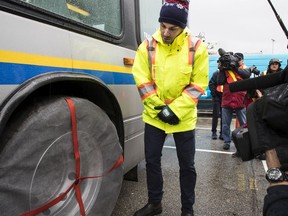 Simon Agnew, maintenance engineer with the Coast Mountain Bus Co., shows off the tire socks that were used for the first time in Metro Vancouver last winter.