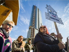 Community members, including Angela Matassa, protest in front of Surrey City Hall on Sunday. A recent decision by the City of Surrey is mandating that homeowners evict their tenants by Jan 31, 2018.