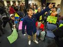 Nathaniel Lowe leads a cheer as residents react to the City of Vancouver rejecting a proposed Chinatown condo development at 105 Keefer St. on Nov. 6.