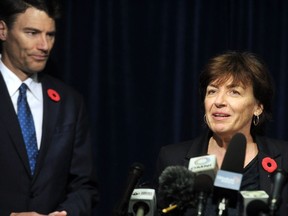 Vancouver's chief finance officer, Patrice Impey, talks about the empty homes owners tax on Tuesday, Nov. 7, 2017, as Mayor Gregor Robertson looks on.