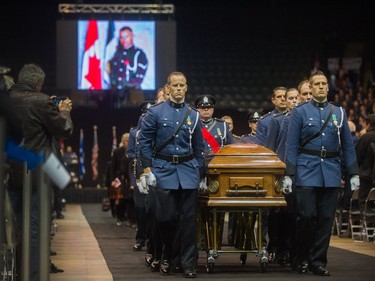 Const. John Davidson's casket is carried in to the Abbotsford Centre for his regimental funeral on Sunday.