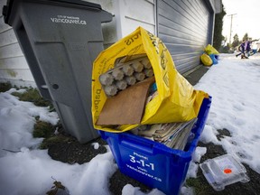 Recycling containers accumulate in the alley behind 97 West 26th, between Ontario and Manitoba streets, in December 2016.