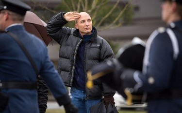 A man salutes the funeral procession carrying the body of Abbotsford Police Const. John Davidson, who was killed in the line of duty Nov. 6, as it makes its way to a memorial service in Abbotsford on Sunday, Nov. 19, 2017.