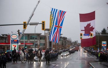The funeral procession carrying the body of Abbotsford Police Const. John Davidson, who was killed in the line of duty Nov. 6, makes its way to a memorial service in Abbotsford, on Sunday, Nov. 19, 2017.