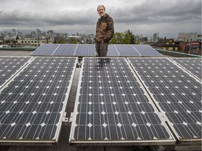 Rob Baxter poses with solar panels on the roof of Vancouver Renewable Energy on April 12, 2016.
