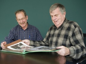 Steve Borthwick (L) looks over a book of memorabilia of his father, Flight Lt. Roy Borthwick, with his cousin Al Borthwick (R), Vancouver, October 31 2017.