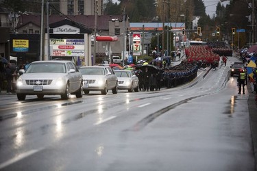 Crowds gather for a final goodbye as a hearse carrying the body of Abbotsford Police Const. John Davidson makes its way through the streets of Abbotsford on Sunday, Nov. 19, 2017. Davidson was shot and killed in the line of duty on Nov. 6.