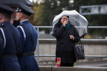 An unidentified woman becomes emotional as a hearse carrying the body of Abbotsford Police Const. John Davidson makes its way through the streets of Abbotsford on Sunday, Nov. 19, 2017. Davidson was shot and killed in the line of duty on Nov. 6.