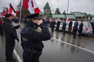 Crowds gather for a final goodbye as a hearse caring the body of Abbotsford Police Const. John Davidson makes its way through the streets of Abbotsford on Sunday, Nov. 19, 2017. Davidson was shot and killed in the line of duty on Nov. 6.