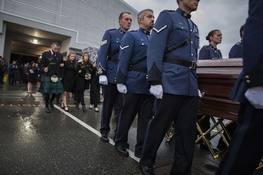 Pallbearers prepare to carry the body of Const. John Davidson after his service in Abbotsford on Nov. 19, 2017.