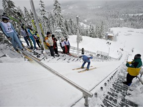 FILE PHOTO - A forerunner clears the track during the trial run of the North American Junior ski jumping team event at the Whistler Olympic Park in the Callaghan Valley.