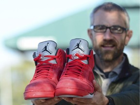 Rev. Joe DeScala of Mended, a non-denominational Christian church, holds up a pair of limited-edition Air Jordan athletic shoes in Port Angeles. DeScala and other community members purchased the shoes to replace those stolen from a 16-year-old Vancouver Island tourist on Oct. 6.