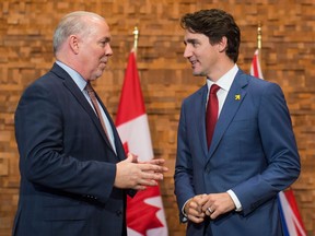 B.C. Premier John Horgan and Prime Minister Justin Trudeau talk during a photo opportunity at Thursday’s Urban Development Institute luncheon in Vancouver on Nov. 16, 2017.
