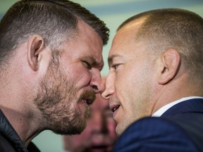 UFC middleweight champion Michael Bisping (left) and challenger Georges St-Pierre go nose to nose during their Oct. 13 news conference promoting their bout at the Hockey Hall of Fame in Toronto.