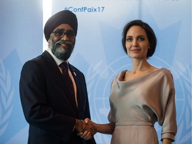 Defence Minister Harjit Sajjan, left, and UNHCR Special Envoy Angelina Jolie shake hands during a photo opportunity before her keynote address at the 2017 United Nations Peacekeeping Defence Ministerial conference in Vancouver, B.C., on Wednesday November 15, 2017.