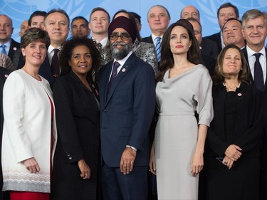 UNHCR Special Envoy Angelina Jolie, front row 4th left, poses with delegates during the family photo at the 2017 United Nations Peacekeeping Defence Ministerial conference in Vancouver, B.C., on Wednesday November 15, 2017. Standing in the front row with her from left to right, are Minister of International Development Marie-Claude Bibeau, Secretary General of La Francophonie Michaelle Jean, Defence Minister Harjit Sajjan and Minister of Foreign Affairs Chrystia Freeland.