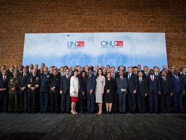 NHCR Special Envoy Angelina Jolie, centre right, stands with Defence Minister Harjit Sajjan, centre left, during the family photo with delegates at the 2017 United Nations Peacekeeping Defence Ministerial conference in Vancouver, B.C., on Wednesday November 15, 2017.