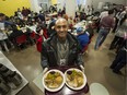 In this photograph from December, 2013, Jemal Damtawe serves up Christmas lunch at the Union Gospel Mission in Vancouver.