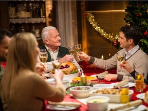 Grandfather raises a toast at a traditional family Christmas.