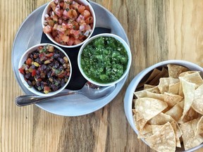 The spicy pico de gallo, black bean & corn and salsa verde with chips appetizer at Taps & Tacos in Port Moody.