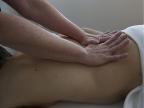 File photo of a massage therapist working on a patient.