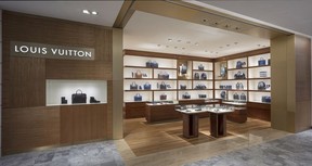 An employee works behind a cash register inside Louis Vuitton's