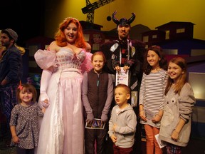 The Good Fairy and the Demon from the Metro Theatre's production of Cinderella meeting with Downtown Eastside families after the show. This year 75 parents and children were bused in from the Strathcona Community Centre to see the show.