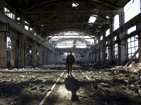 An Ukrainian serviceman walks through the rubble of a destroyed workshop after fighting with pro-Russian separatists in Avdiivka, Donetsk region on March 31, 2017.