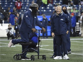 Cornerback Richard Sherman, out for the season with an Achilles injury, jokes with Seattle Seahawks' coach Pete Carroll. The Seahawks need to win Sunday against the visiting Los Angeles Rams.