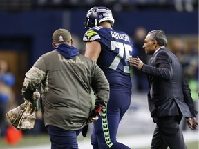 Oday Aboushi #75 of the Seattle Seahawks is helped off the field in the fourth quarter of the game against the Atlanta Falcons at CenturyLink Field on November 20, 2017. He has now been placed on injured reserve.