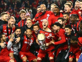 Captain Michael Bradley of Toronto FC lifts the championship trophy after winning the 2017 MLS Cup final 2-0 over the Seattle Sounders at BMO Field in Toronto on Saturday, Dec. 9, 2017.