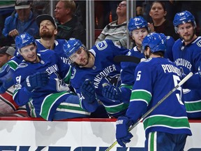 Derrick Pouliot is congratulated after scoring the game-winning goal Tuesday.