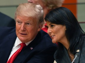 Donald Trump and U.S. ambassador to the United Nations Nikki Haley speak during a meeting on United Nations Reform at the United Nations headquarters on September 18, 2017, in New York.