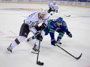 Vancouver Canucks' defenceman Ben Hutton, right, shown keeping sniper Jeff Carter of the Los Angeles Kings on the outside, has been a healthy scratch for the past two games.