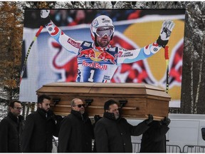 People carry the coffin of late French skier David Poisson during a ceremony in his memory in Peisey-Nancroix, in the French Alps, on November 26, 2017.  French skier David Poisson, a downhill bronze medallist at the 2013 world championships, was killed during a training accident in Canada on November 13, 2017.