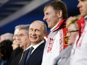 Russian President Vladimir Putin, centre, stands next to Alexander Zubkov, gold medalist in the two-man and four-man bobsleigh for Russia, during the Closing Ceremony of the Sochi Winter Olympics at the Fisht Olympic Stadium. Russia was banned from the 2018 Winter Games by the International Olympic Committee (IOC) over its state-orchestrated doping programme. Zubkov, who carried the Russian flag at the opening ceremony in Sochi, was removed from the 2014 records in the latest round of verdicts from the IOC and banned for life from the Olympics.