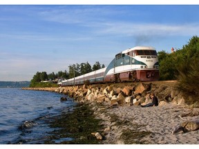 The Amtrak Cascades train cruising by the Puget Sound waterfront in Edmonds, Washington.  [PNG Merlin Archive]