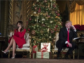 President Donald Trump and first lady Melania Trump speak on the phone with children as they track Santa Claus' movements with the North American Aerospace Defense Command (NORAD) Santa Tracker on Christmas Eve at the president's Mar-a-Lago estate in Palm Beach, Fla., Sunday, Dec. 24, 2017.