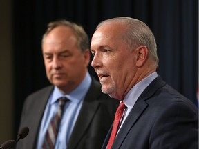 Premier John Horgan, right, says he's become better at selling his ideas by working with Green Party Leader Andrew Weaver, who doesn't always agree with him or his party's positions.