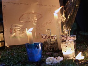 Pictures and notes in from friends and classmates make up a memorial in support and memory of Aubrey Berry, 4, and her sister Chloe, 6, during a vigil held at Willows Beach in Oak Bay, B.C., on Saturday, December 30, 2017.