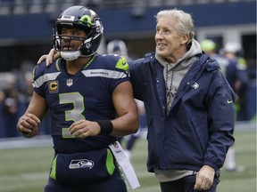 Seattle Seahawks coach Pete Carroll, right, stands with quarterback Russell Wilson before the team's NFL football game against the Los Angeles Rams in Seattle.