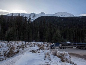Snowbanks line the Trans Canada highway at Rogers Pass on Wednesday, March 4, 2015. Parks Canada is investigating a recent incursion into a prohibited area that's regularly bombed to bring down avalanches along the highway through Rogers Pass, B.C.
