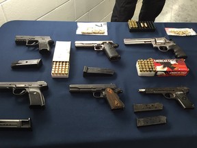 Police say they have made a significant seizure of guns, ammunition and explosive devices from suspects who've been involved in the Lower Mainland gang conflict. Pictured is a selection of firearms being displayed by police on Dec. 6.