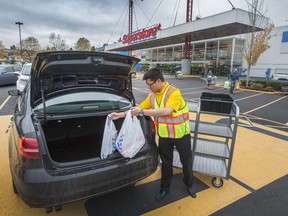 Darius Tsui places into a trunk at Real Canadian Superstore in Vancouver, BC. November 10, 2015. Loblaws, parent company of names such as Real Canadian Superstore is offering customers a $25
gift card as a goodwill gesture after admitting the company
participated in an industry-wide bread price-fixing arrangement.