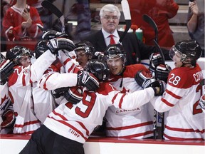 The late Pat Quinn, a former part-owner of the Vancouver Giants, looks on as Team Canada's head coach in 2009 as John Tavares is mobbed by teammates after scoring the game-winning goal against Team Russia in a semifinal shootout at the world junior hockey championship in Ottawa.
