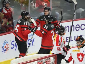 Canada's Jordan Kyrou (25) celebrates his goal with teammates during first period World Junior exhibition hockey action against Switzerland, in Hamilton, Ont., on Friday, December 22, 2017.